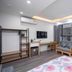 Ann's Hotel & Apartment in Hanoi guest room with twin beds, sofa, desk, and large windows