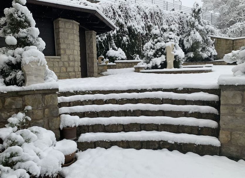 Snow-covered stone steps and courtyard at Antik Hotel Sofia, Litomyšl