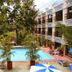 Hotel Doralba Inn in Mérida courtyard pool surrounded by palm trees and balconies