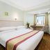 Dalian Jinbai International Hotel room in Dalian with double bed, city view window and wall-mounted TV