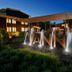 Vann Spa Hotell & Konferens in Brastad with illuminated fountain and landscaped courtyard at dusk