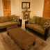Hotel Cocomar Beachfront Hotel in Parrita living area with two sofas, woven coffee table, and mirror