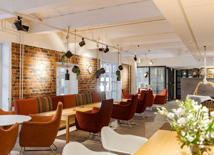Original Sokos Hotel Villa in Tampere lobby lounge with brick wall, pendant lights, and seating area