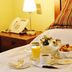 Oporto Hotel Boutique in Santiago room service breakfast tray on a bed with lamp and phone