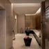 Waldorf Astoria Ras Al Khaimah spa lounge with curved seating and candlelit, textured walls