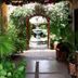 The Mexican Inn in Cabo San Lucas: lush garden walkway leading to a fountain courtyard