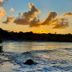 Beach Hotel Jacuma in João Pessoa with a sunset over the ocean and waves washing the shoreline