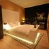 Hotel & Spa Savarin in Rijswijk bedroom with illuminated bed and dark curtains