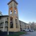 Super 8 by Wyndham The Woodlands North in Shenandoah, exterior with clock tower and parking lot