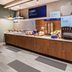 Holiday Inn Express & Suites Fredericksburg breakfast bar with coffee, eggs, milk and yogurt dispensers