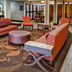 Hampton Inn Russellville lobby seating area with patterned sofas, chairs and coffee tables