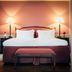 Stallmästaregården Hotel, Stockholm: cozy double bed with plaid headboard, bench, and bedside lamps