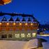 HG Alto Aragón in Formigal at night, showing a snow-covered alpine hotel with lit windows and mountain backdrop