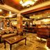 Welcome Hotel at Srinagar lobby with sofas, coffee table, wood beams and chandeliers