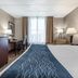 Comfort Inn & Suites Glen Mills - West Chester guest room with king bed, desk, TV and window seating