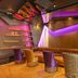 Tulip City Hotel & Spa in Istanbul lounge with tufted sofa, colorful chairs and purple ambient lighting
