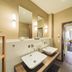 Flair Hotel zum Schiff, Meersburg: modern twin sinks in a hotel bathroom leading to a guest room