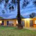 Cootamundra Gardens Motel in Cootamundra with single-story motel rooms and grassy grounds at dusk