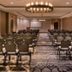 DoubleTree by Hilton Raleigh Crabtree Valley meeting room with rows of banquet chairs and a projector screen