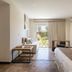 Villa Mansa room in Luján de Cuyo with bed, sitting area, and patio doors to a garden view