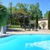 Résidence Les Peupliers in Loriol-du-Comtat: outdoor pool with lounge chairs and shaded pergola