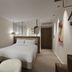 Hotel & Spa Amoria La Baule room with queen bed, armchairs, and sleek modern decor in La Baule-Escoublac