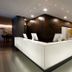 Hotel Cercano Gramado reception desk with modern dark wood lobby and white illuminated front desk