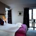 Ballyrobin Hotel in Crumlin guest room with king bed, balcony door and dark curtains