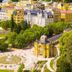 Sun Palace Wellness Hotel in Mariánské Lázně overlooking a park with fountain and colorful historic buildings