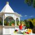 Bahia Del Duque in Adeje: white gazebo-style outdoor bar with colorful tropical drinks and lush garden setting