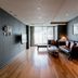 Oriens Hotel & Residences Myeongdong Seoul living room with sofa, coffee table and balcony view