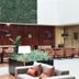 The Pearl Troia in Tróia lounge with bar seating, plants, and modern sofas under a high atrium