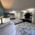 Studio 6 Huntsville, Al University Drive room with two beds, TV, and vanity area in Huntsville