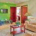 Las Brisas Resort and Villas in Jacó: colorful villa living room with beige sofa and coffee table