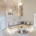 Levantes Ios Boutique Hotel in Mylopotas features a stylish white lounge with built-in corner seating and stairs