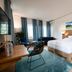 Landhotel Kauzenberg, Bad Kreuznach: bright guest room with double bed, seating area, and large window