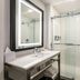 Four Points by Sheraton Elkhart bathroom with glass shower, vanity sink and large mirror