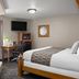 Super 8 by Wyndham Lewistown guest room with king bed, desk, TV, and window seat