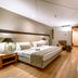 Pestana São Paulo hotel room in Sao Paulo with king bed, sitting area, and wood flooring