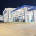 Americas Best Value Inn & Suites in Senatobia exterior at night with parking lot and blue roof