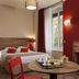 Aparthotel Adagio Lyon Patio Confluence room with double bed, round table, and window in Lyon