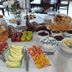 Altos Ushuaia Hotel & Resto breakfast buffet with fruit, pastries, eggs and yogurt in Ushuaia