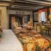 The Tudor House Hotel, Tewkesbury: colorful bedroom with floral bedspread, desk, and fireplace