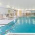 Hampton Inn Battle Creek indoor pool with lounge chairs and seating area in Battle Creek