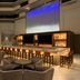 Embassy Suites by Hilton Phoenix Downtown North bar lounge with high stools and blue-lit wall in Phoenix