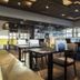 Strandhotel Vigilante in Makkum dining room with tables, chairs and bar seating