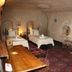 Cappa Villa Cave Hotel & Spa in Ürgüp, cave-style guest room with twin beds and patterned rugs