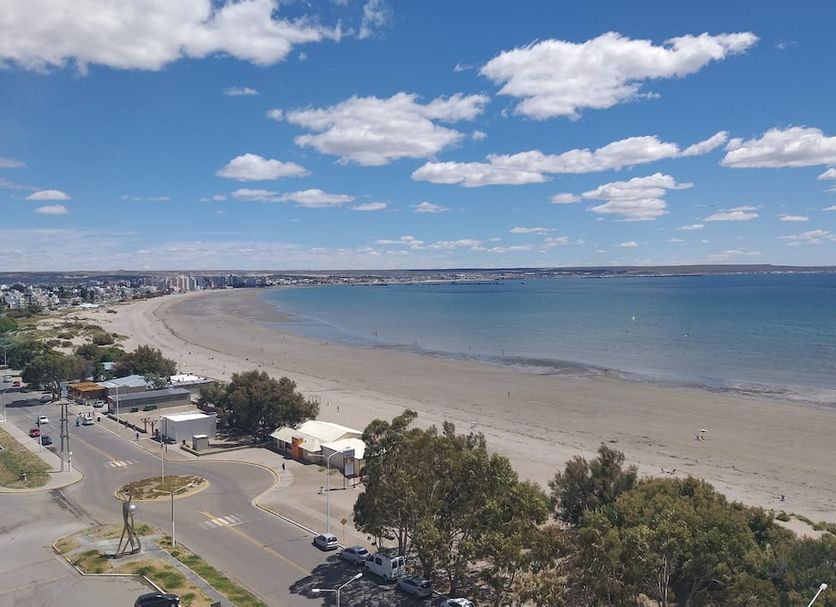 Rayentray Grand Hotel in Puerto Madryn overlooking a wide sandy beach and calm blue ocean