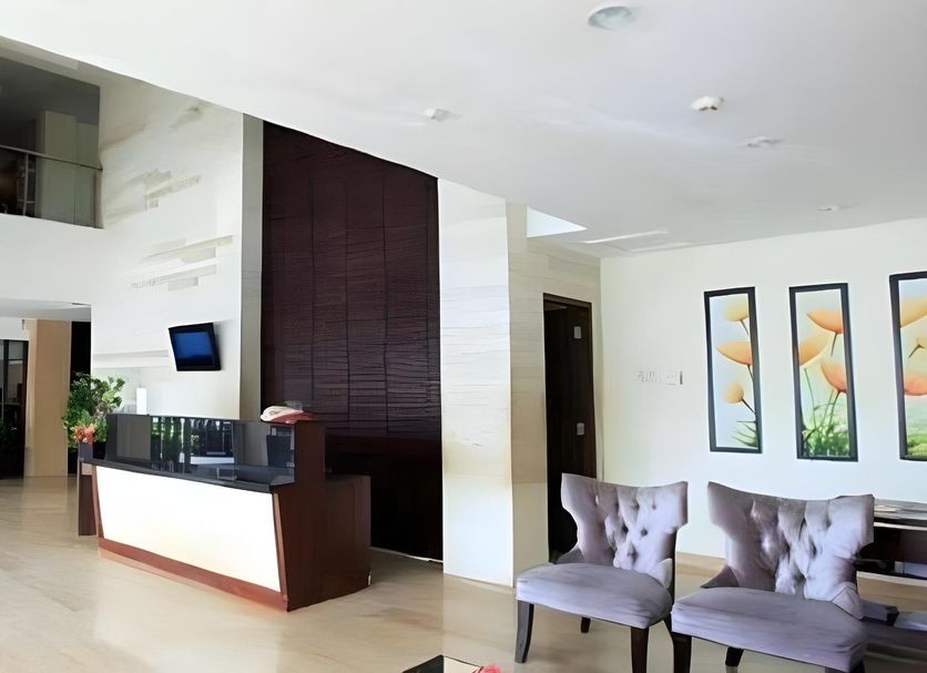 Cititel Hotel Pekanbaru lobby with reception desk, lounge chairs, and high ceiling in Pekanbaru