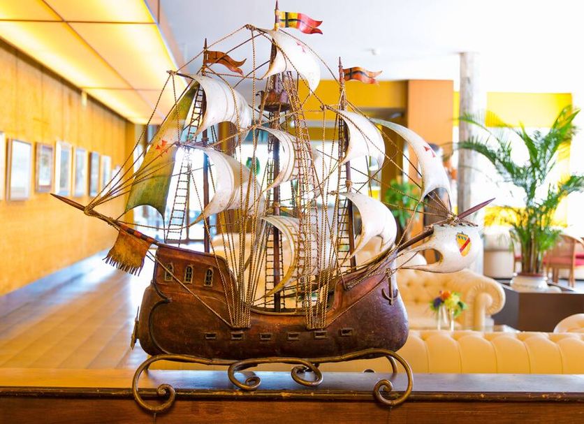 Hotel Principe Bibione lobby with large decorative sailing ship model and seating area